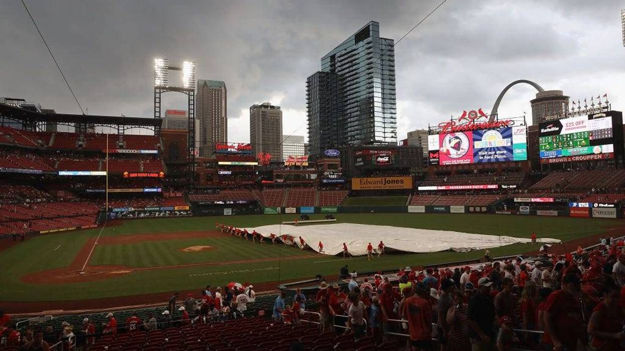 The grounds crew pulls a tarp over the infield prior to a thunderstorm delaying a game between the St. Louis Cardinals and the Pittsburgh Pirates at Busch Stadium on June 27, 2021 in St Louis, Missouri.