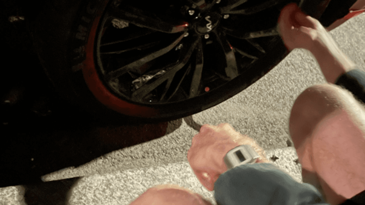 The group posted a picture from Wednesdays raid of two activists kneeling over a tire.