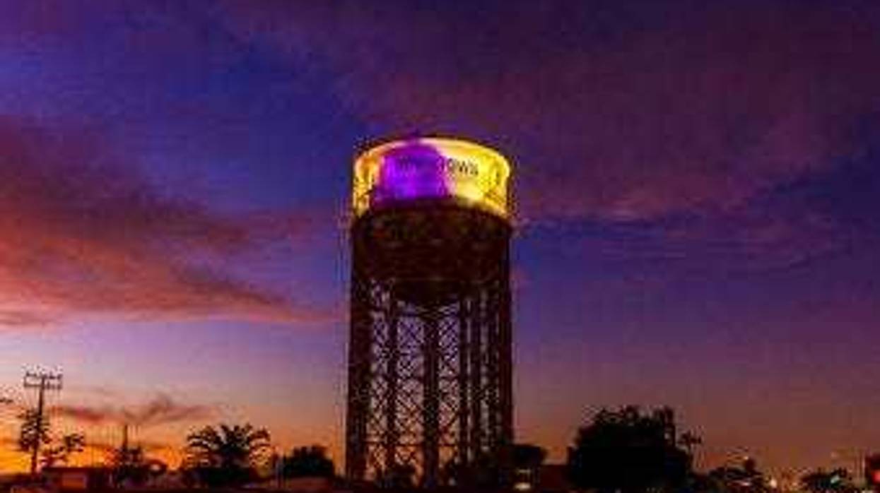 The historic 1928 Santa Ana water tower in Santa Ana, Calif., Monday, Jan. 27, 2020, is illuminated in purple and gold light in remembrance of Los Angeles Lakers legend Kobe Bryant. (Leonard Ortiz/The Orange County Register via AP)