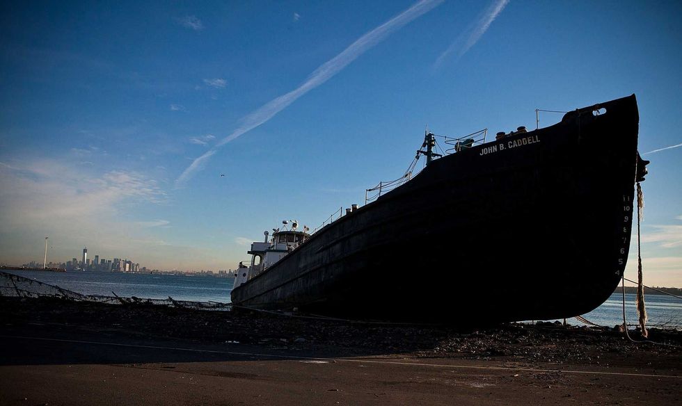 The John B. Caddell tanker sits on the shore of Staten Island on Nov. 1, 2012, after running aground during Sandy. The Manhattan skyline is visible in the distance