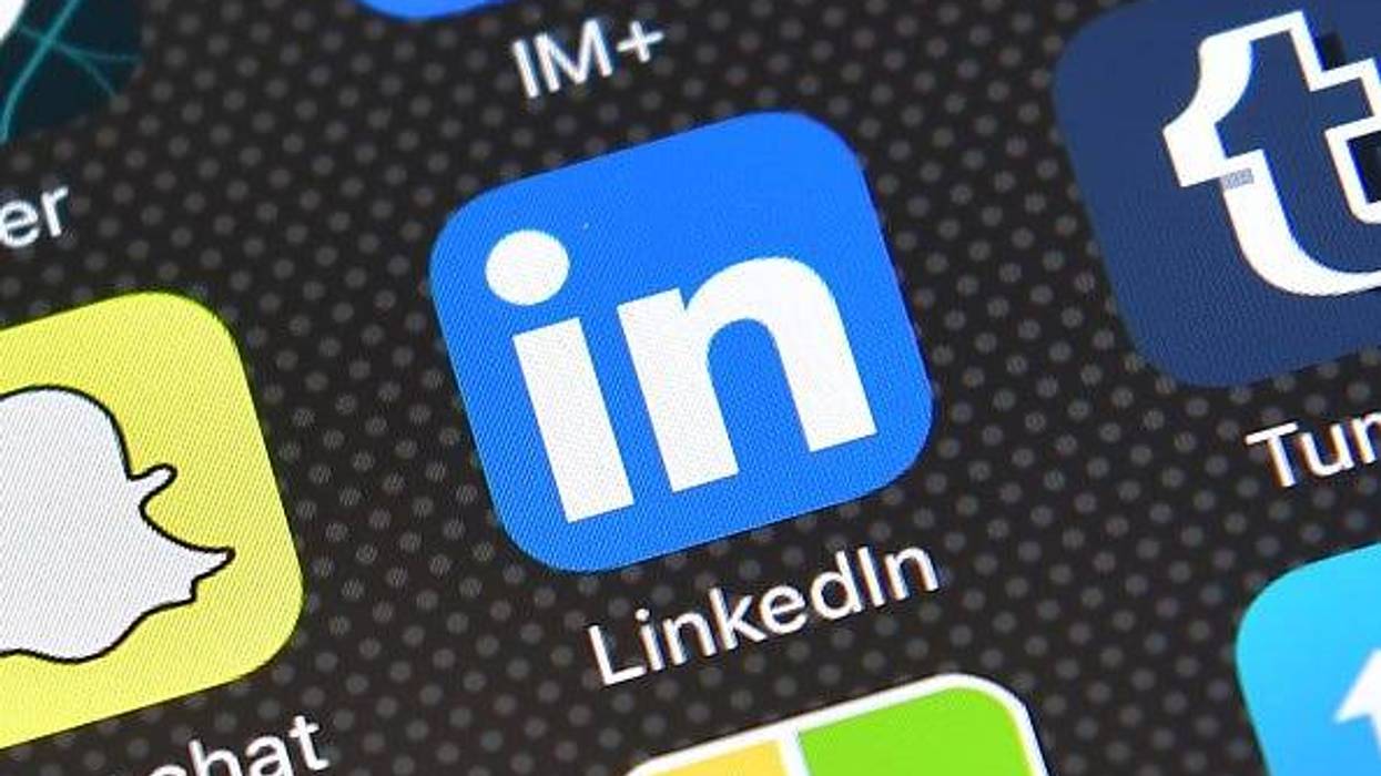 The LinkedIn app logo is displayed on an iPhone