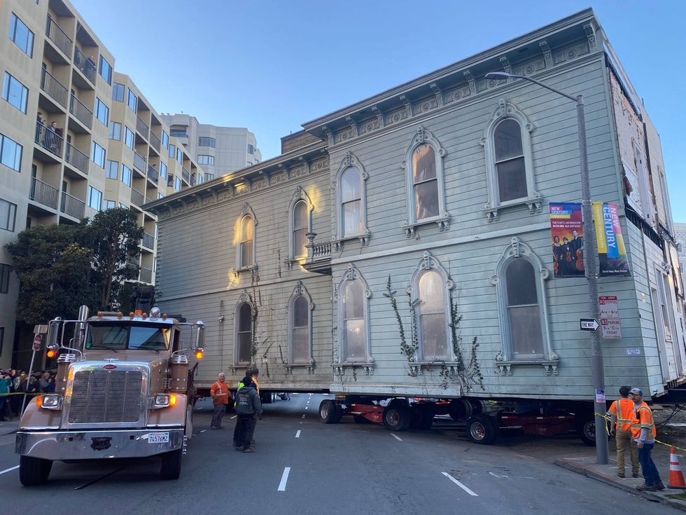 The long house squeak around a corner on Fulton St. during its move in downtown San Francisco on Sunday morning.
