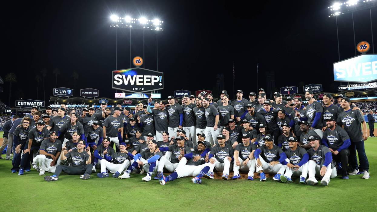 The Los Angeles Dodgers pose for a photo after defeating the Milwaukee Brewers 5-1 to in game four of the National League Championship Series at Dodger Stadium on October 17, 2025 in Los Angeles, California.