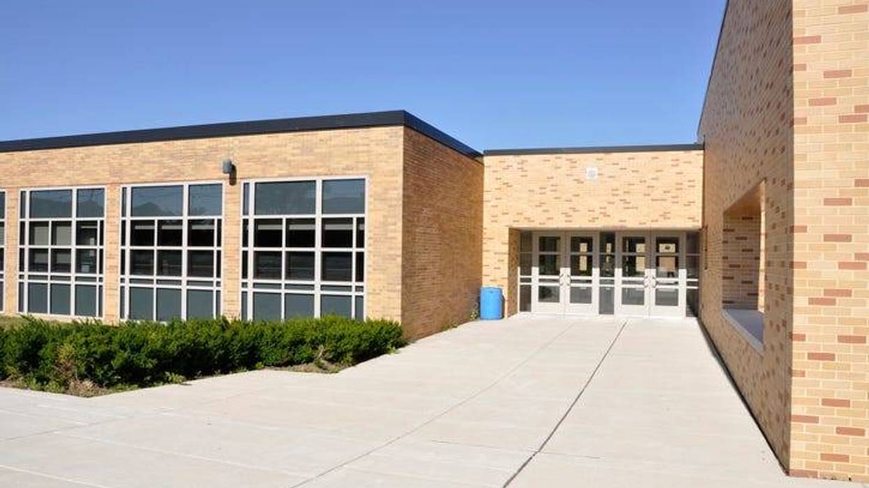 The main walkway leading up to a high school on a sunny day