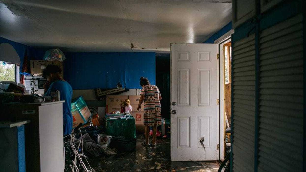 The Maldonado family walk through their home after it flooded during Hurricane Ida.