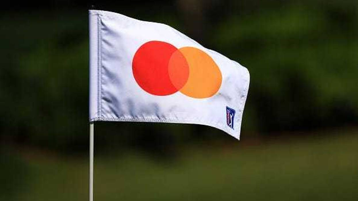 The Mastercard logo on a golf flag.