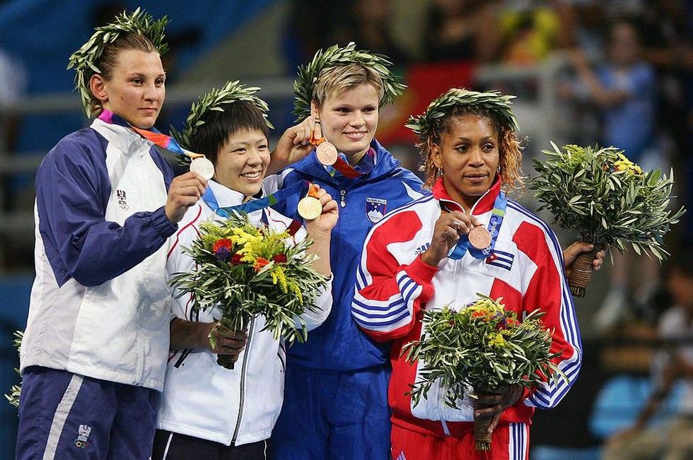 The medal winners (L-R) Claudia Heill (silever) of Austria, Ayumi Tanimoto (Gold) of Japan, Urska Zolnir (Bronze) of Slovenia and Driulys Gonzalez (Bronze) of Cuba pose for photographers after the women