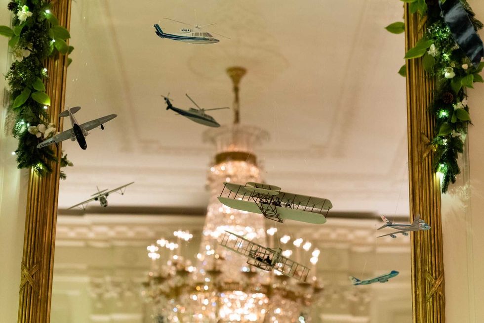 The mirrors of the East Room of the White House are decorated with planes for the Christmas season Sunday, Nov. 29, 2020.