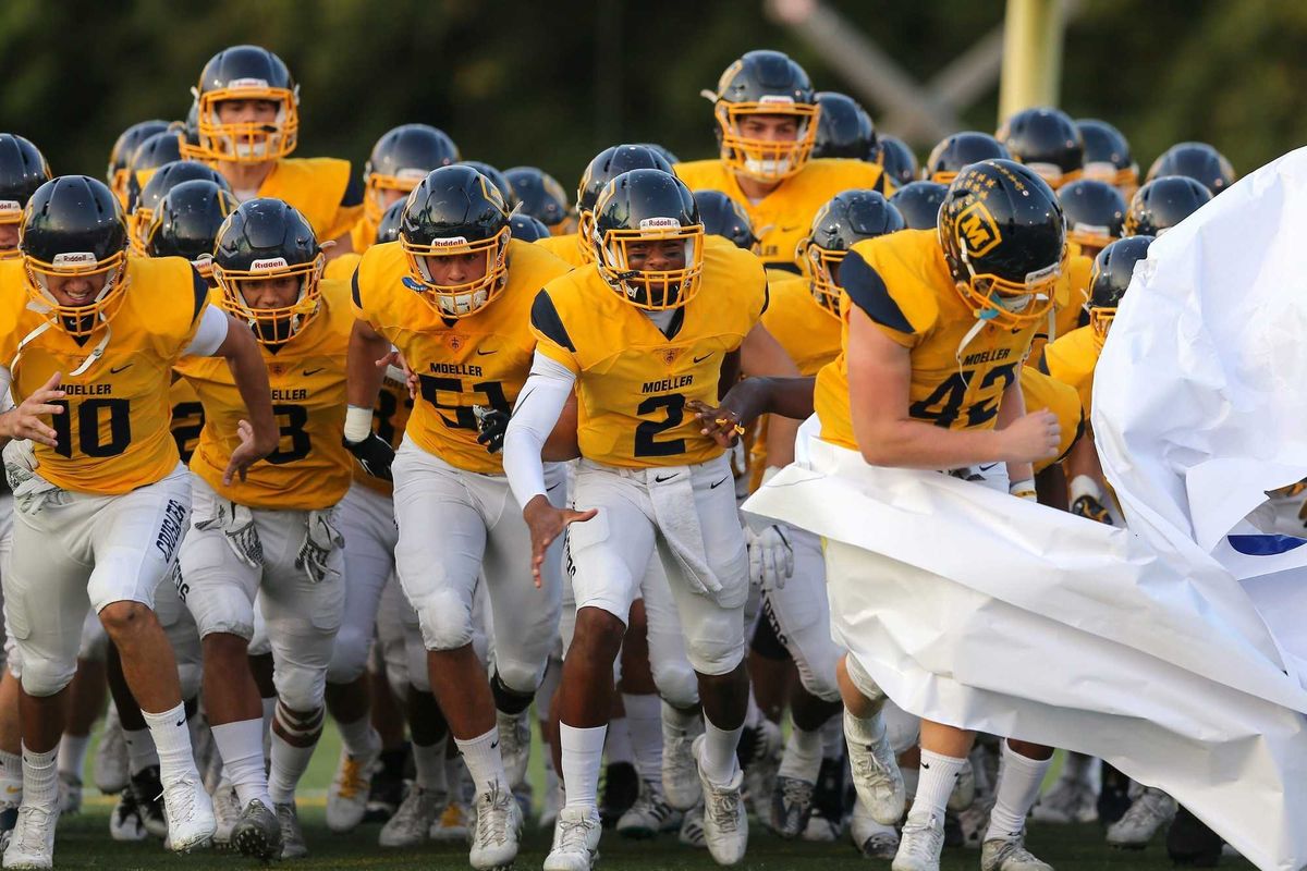 The Moeller Crusaders take the field before the high school football game between the St. Xavier Bombers and Moeller Crusaders, Friday, Sept. 22, 2017, at Roettger Stadium in Lockland, Ohio.