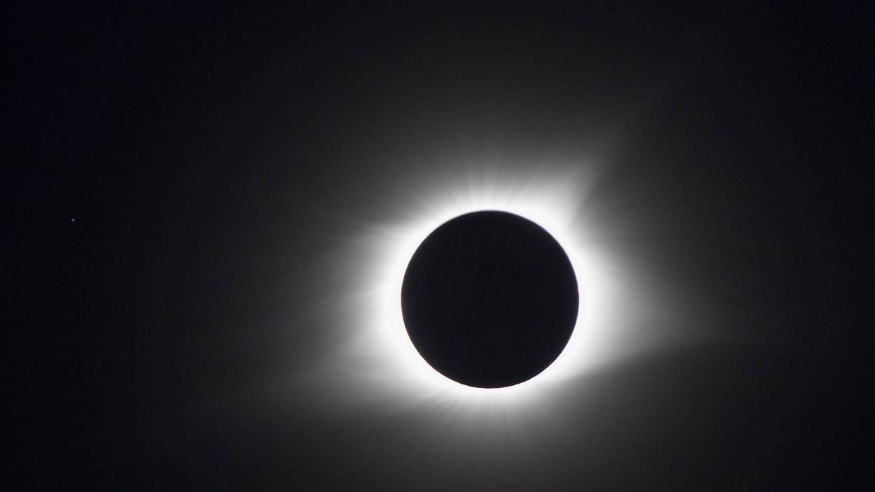 The moon blocks the sun but the sun's corona goes around the moon during a total solar eclipse's transit across the United States, August 21, 2017 in Hopkinsville, Kentucky.