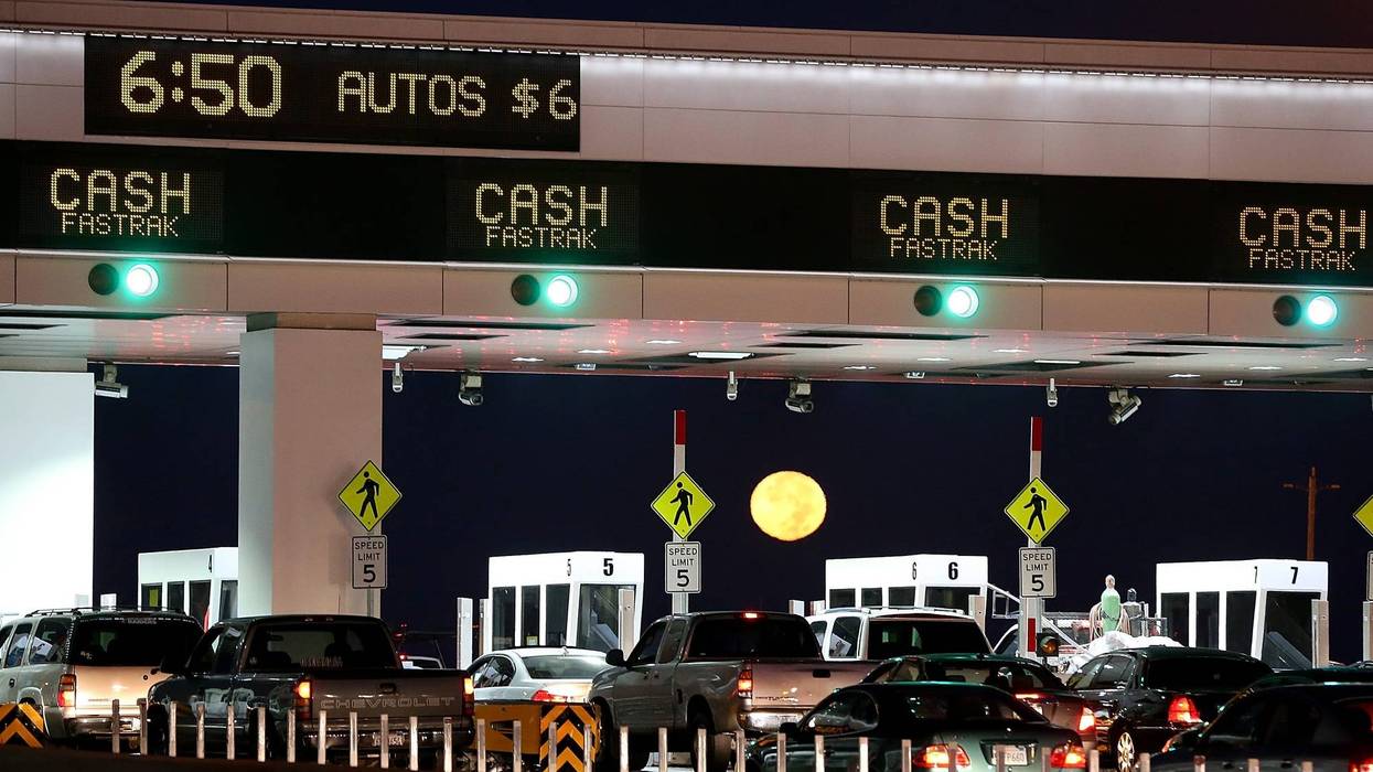 The moon sets as traffic backs up at the San Francisco-Oakland Bay Bridge toll plaza while commuters make their way into San Francisco on the first day of the (Bay Area Rapid Transit) BART strike on October 18, 2013 in Oakland, California.