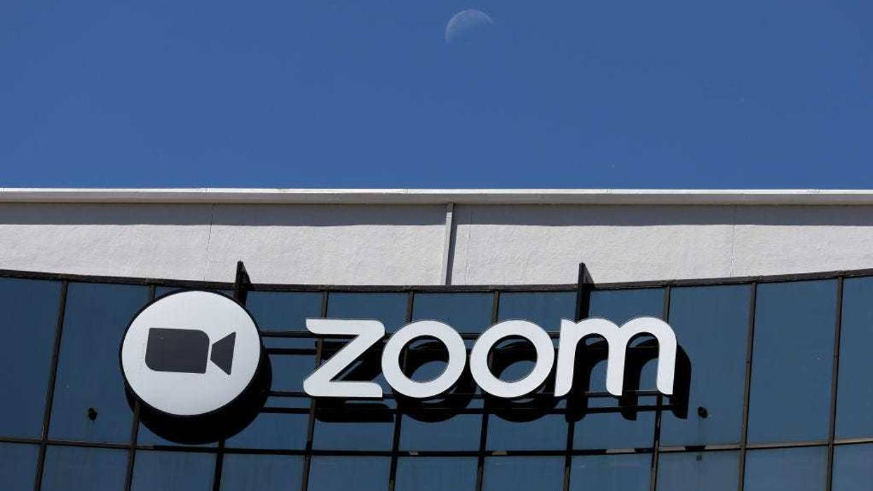 The moon sets behind the Zoom Video Communications headquarters on May 23, 2022 in San Jose, California.