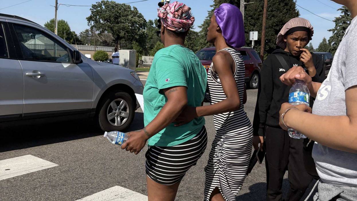 The mother of 11-year old Amir Lamar Atkins near where he was shot and killed in north Minneapolis Monday afternoon.