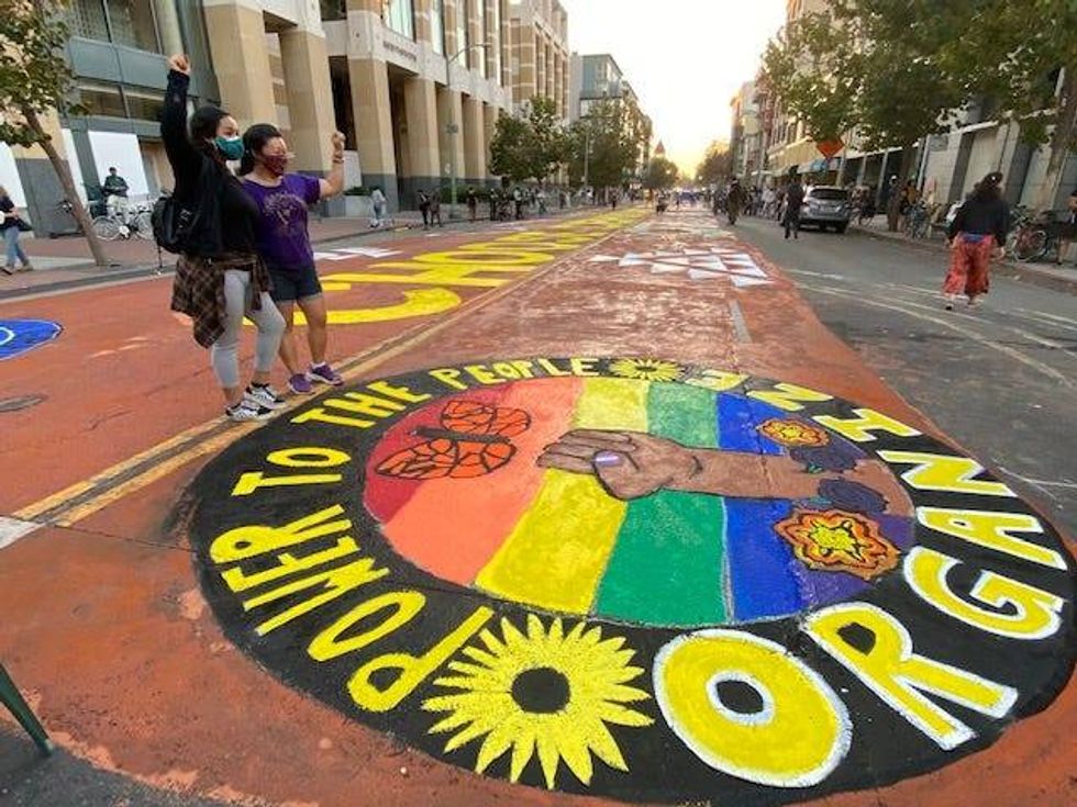The mural in downtown Oakland reads "Power To The People" and "Organize."