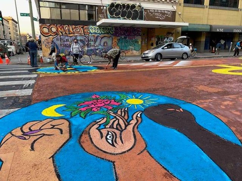 The mural was created using clay from tribal lands in the Bay Area, so it will wash away in an environmentally-friendly way during the next rain.