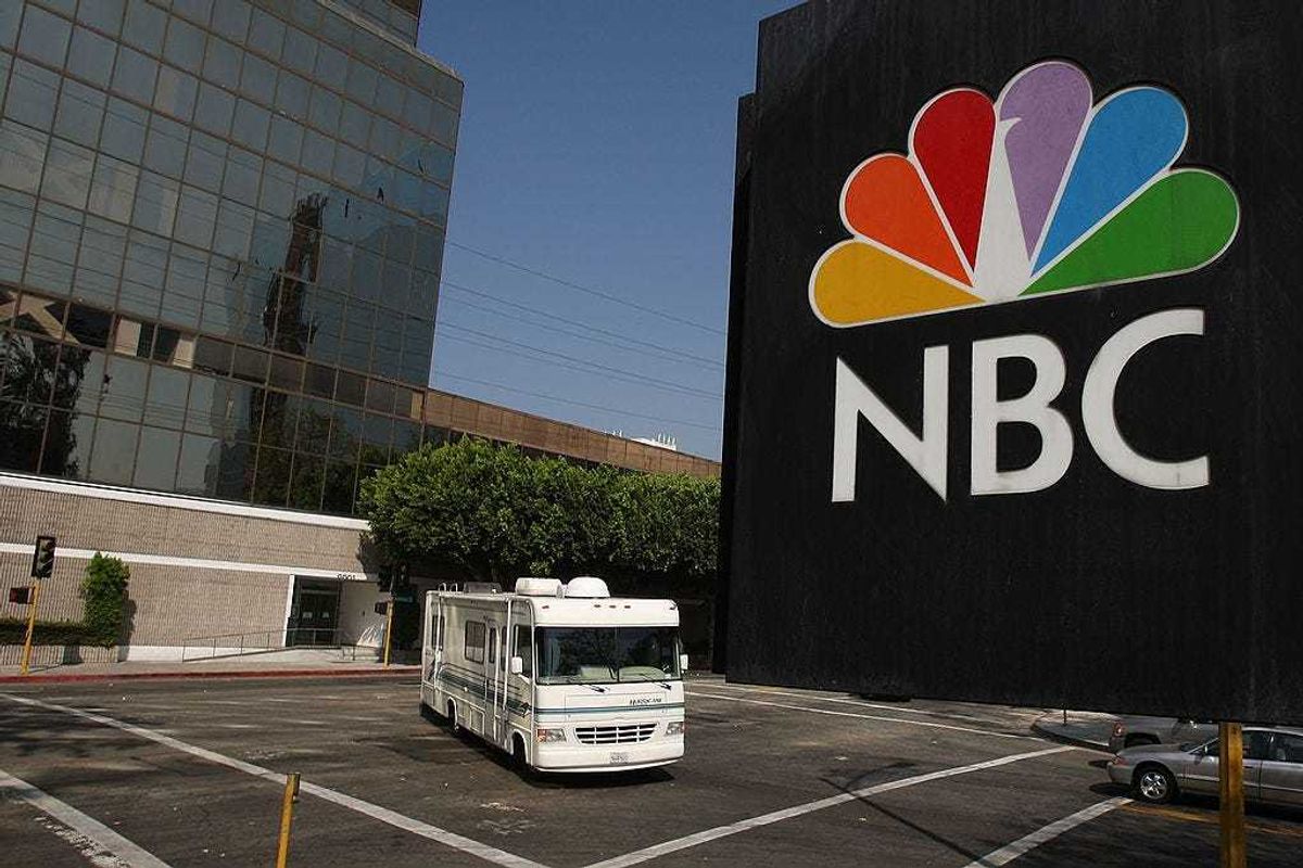 The NBC peacock logo hangs on the NBC studios building as a mobile home is parked nearby on October 20, 2008 in Burbank, California.