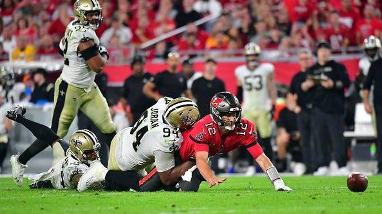 The New Orleans Saints tackle and force Tom Brady to fumble