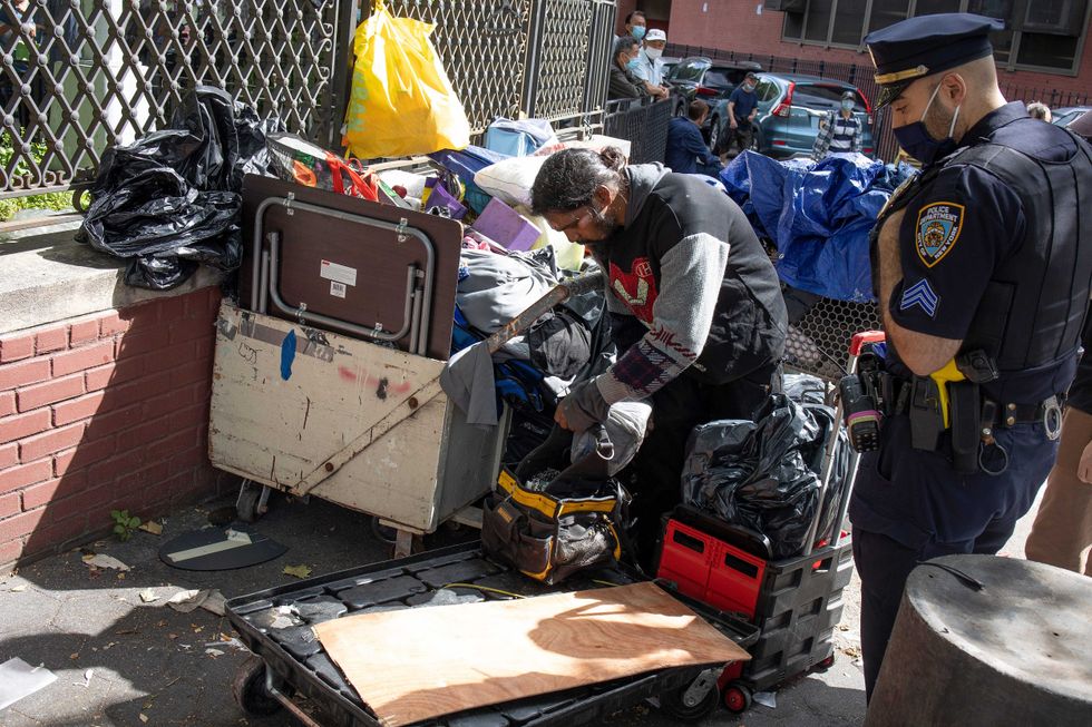 The New York City Department of Sanitation, backed up by police officers, conduct enforced removals of homeless encampments on June 23, 2022 in Chinatown.