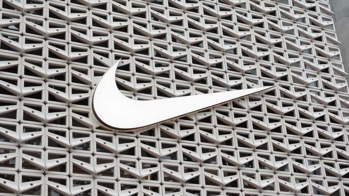 The Nike logo hangs above the entrance to the Nike store on December 21, 2021 in Miami Beach, Florida.
