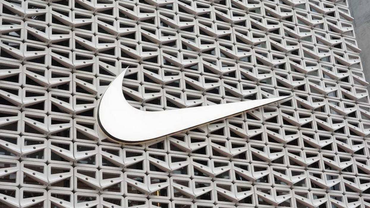 The Nike logo hangs above the entrance to the Nike store on December 21, 2021 in Miami Beach, Florida.