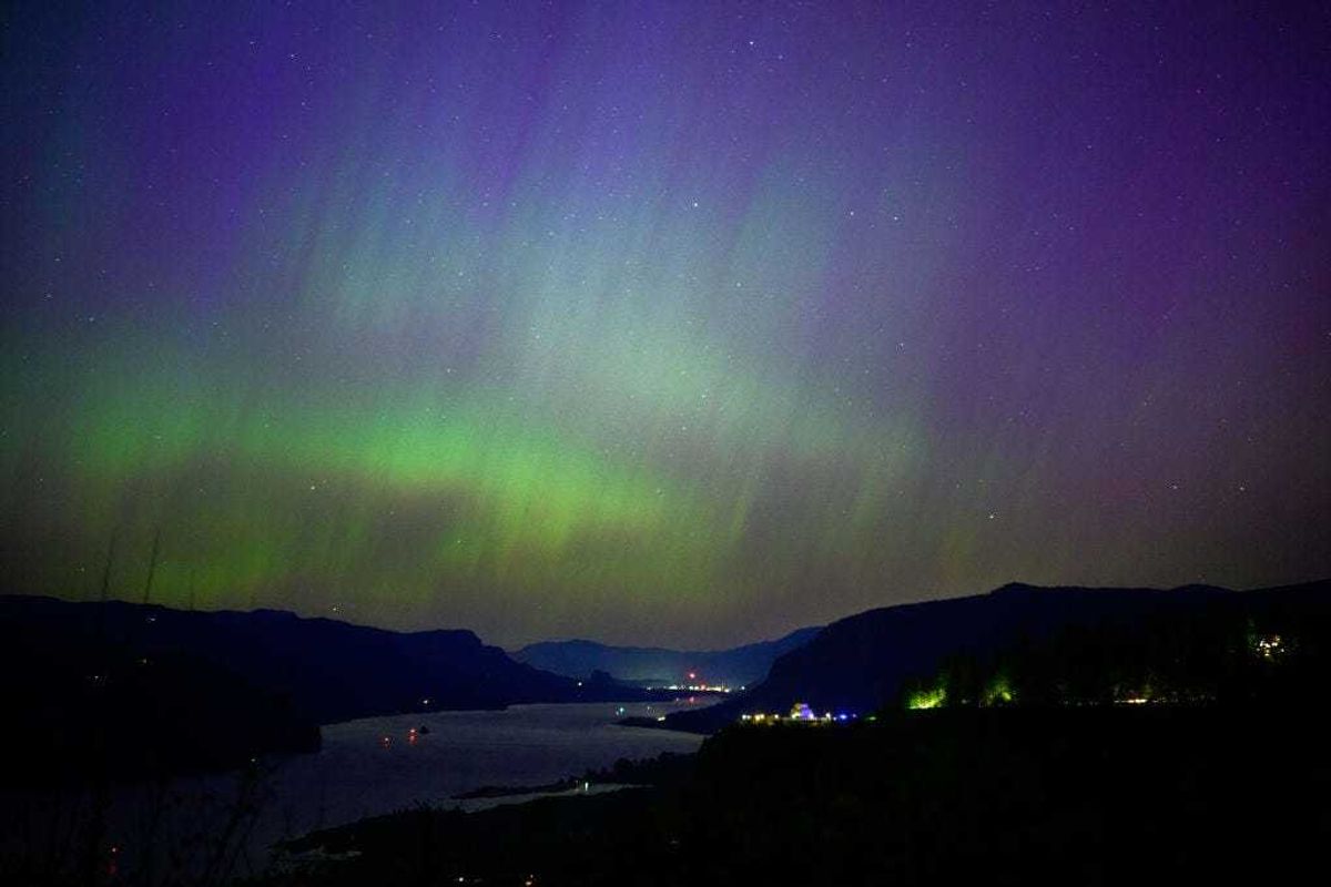 The Northern Lights are seen above the Columbia River Gorge from Chanticleer Point Lookout in the early morning hours of May 11, 2024 in Latourell, Oregon.