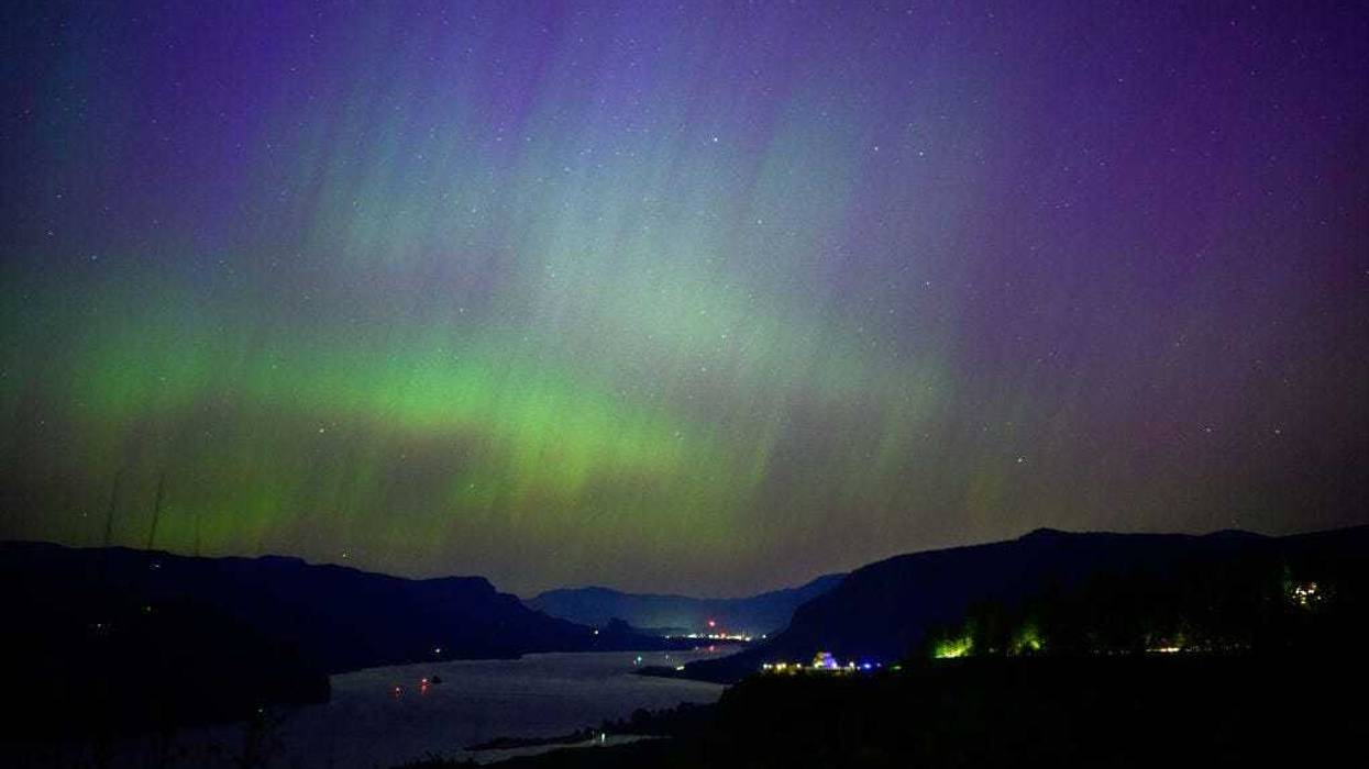 The Northern Lights are seen above the Columbia River Gorge from Chanticleer Point Lookout in the early morning hours of May 11, 2024 in Latourell, Oregon.