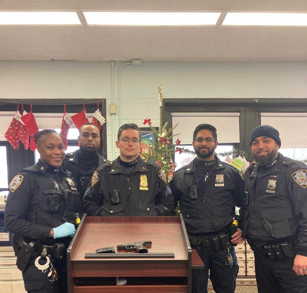The officers involved in the rescue of the French Bulldog and arrest of the armed dognapper.