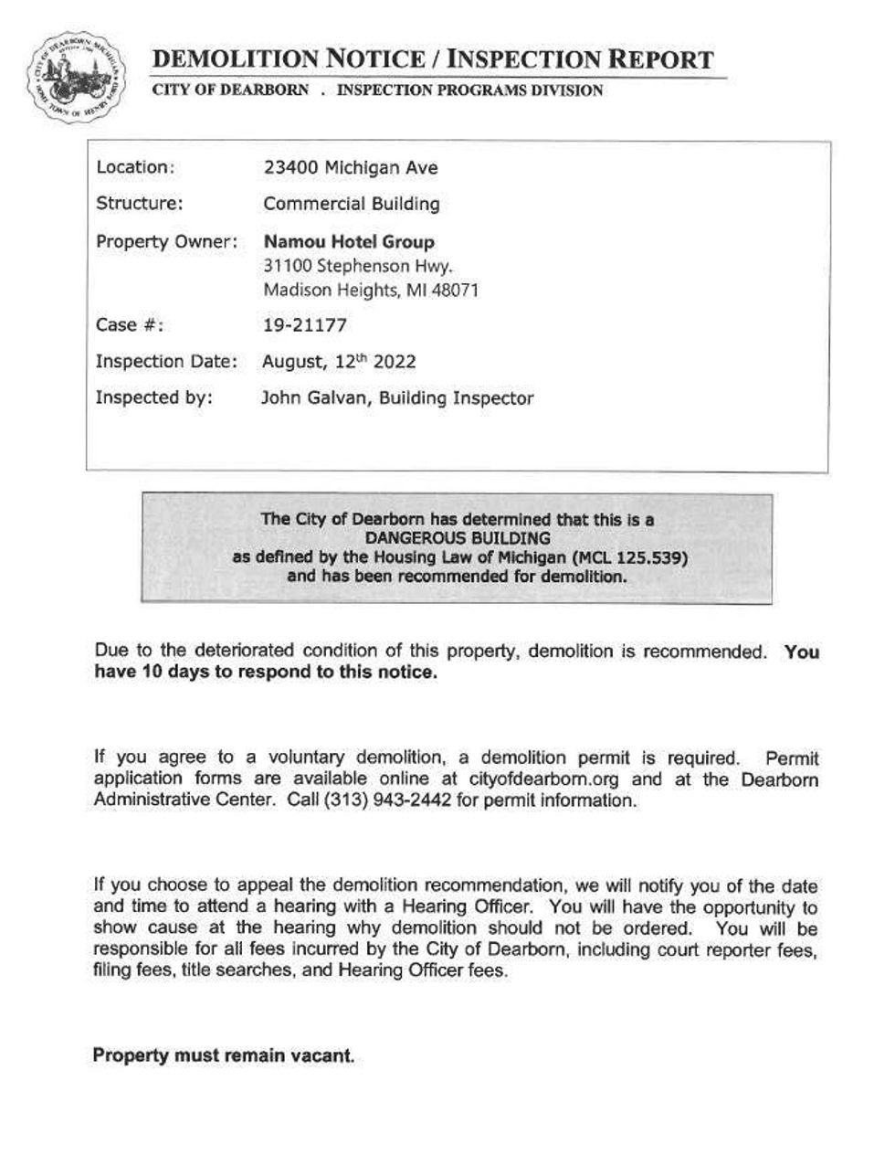 The official demolition notice served to Namou Hotel Group. The notice declares the property a "dangerous building" and provides instructions for agreeing to voluntary demolition or appealing the demolition.