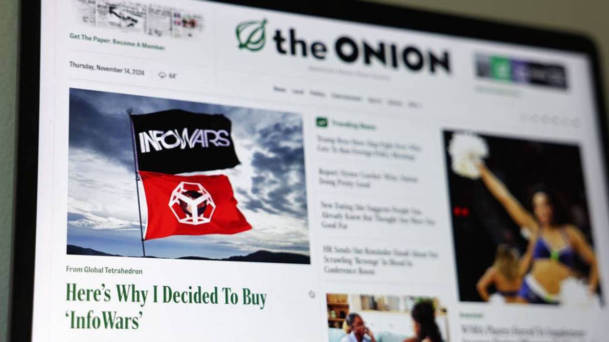 The Onion website displaying an article 'Here's Why I Decided To Buy InfoWars' with InfoWars flags.