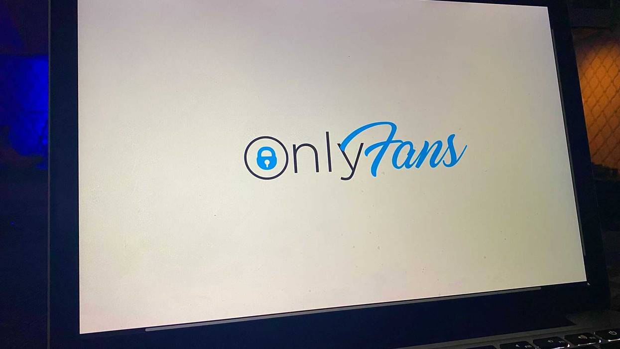 The OnlyFans website loading on a laptop.