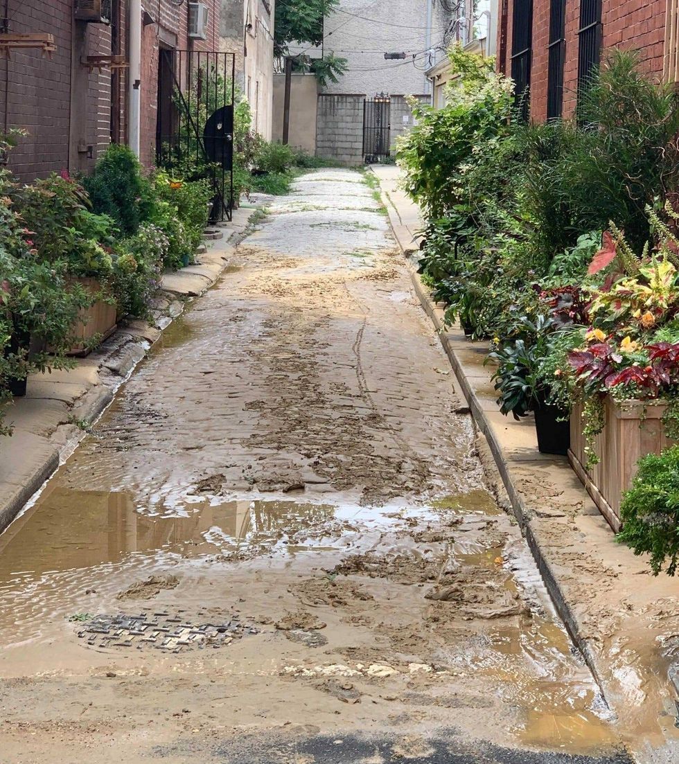 The overnight water main break left mud throughout the Queen Village neighborhood.