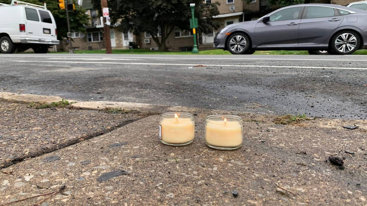 The owner of a day care center on Haverford Avenue lit these candles to remember the 35-year-old man who died yesterday. She learned he was killed here on his birthday.