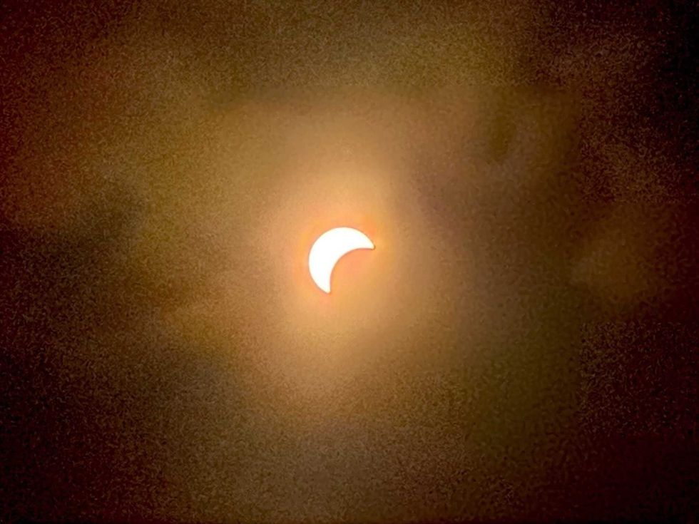The partial Eclipse is seen from the rooftop of 345 Hudson St., New York.