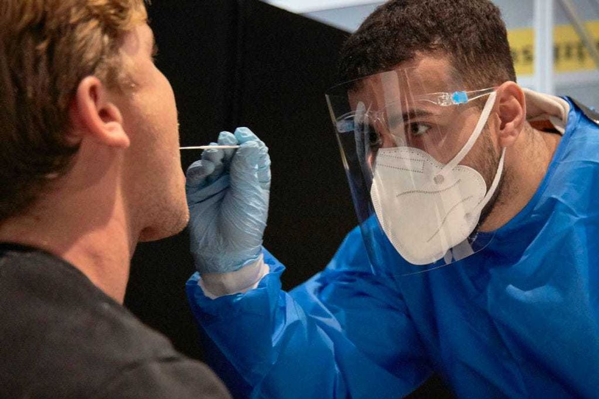 The passenger of a flight from South Africa is tested for the Coronavirus at Amsterdam Schiphol airport on December 2, 2021 in Amsterdam, Netherlands.