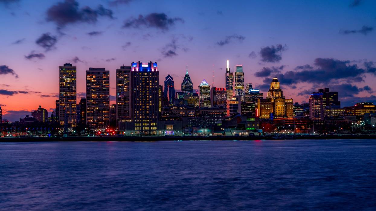 The Philadelphia Skyline from the Delaware River after sunset with illuminated skyscrapers