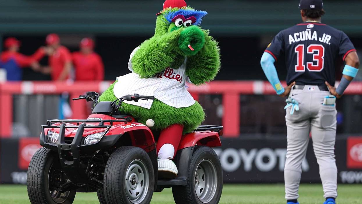 The Phillie Phanatic reacts with Atlanta Braves outfielder Ronald Acuña Jr. (13) before action at Citizens Bank Park.