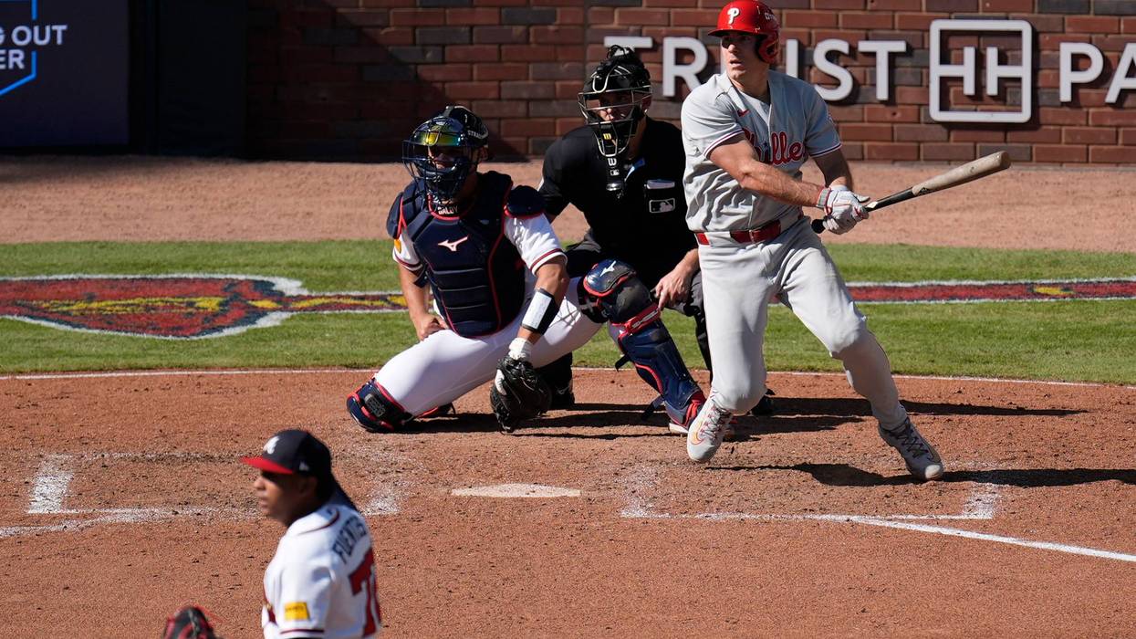 The Phillies' J.T. Realmuto hits a two-run triple off Atlanta Braves pitcher Didier Fuentes in the seventh inning during Game 1 of baseball's National League Wild Card Series Tuesday, Sept. 29, 2026, in Atlanta.
