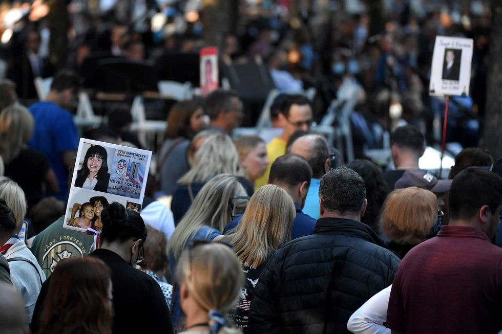 The photo of a 9/11 victim is carried by family and friends as they attend a ceremony commemorating the 20th anniversary of the 9/11 attacks on the World Trade Center on September 11, 2021 in New York City
