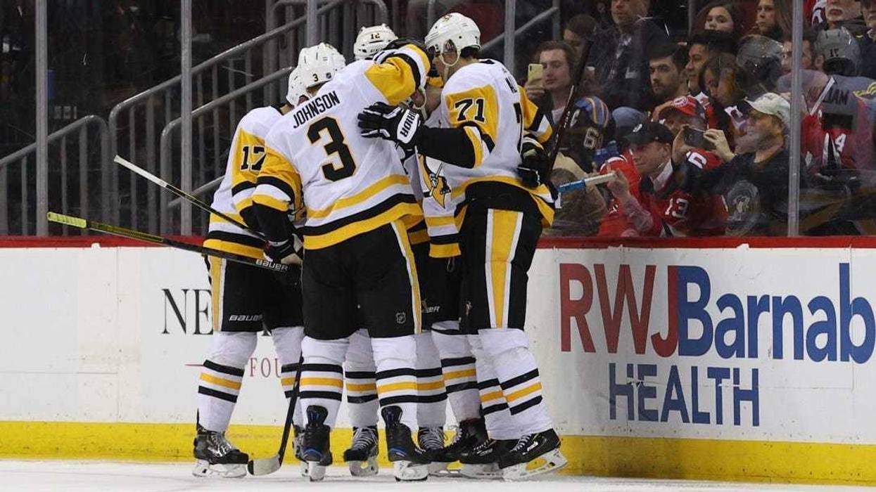 The Pittsburgh Penguins celebrate after a goal by defenseman Justin Schultz (4) against the New Jersey Devils during the second period at Prudential Center.