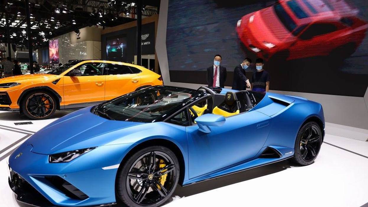 The potential consumers look at a Lamborghini car during 2020 Beijing International Automotive Exhibition at China International Exhibition Center on September 27, 2020, in Beijing.