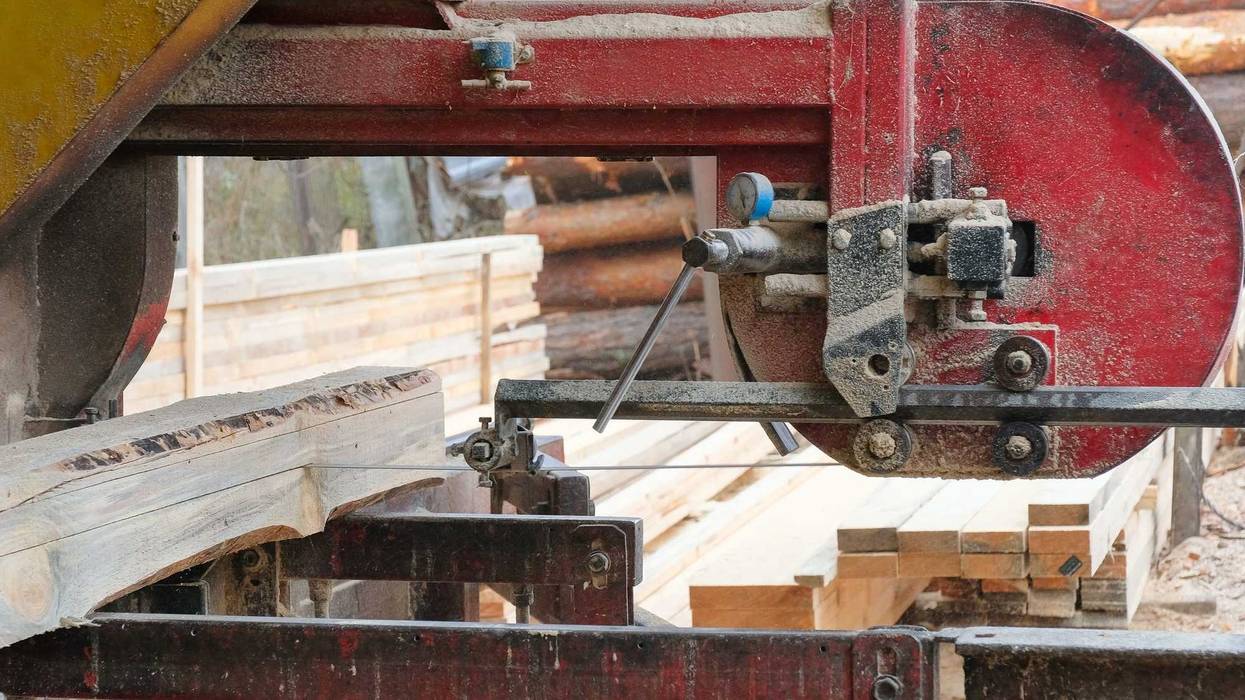 The process of processing logs on the equipment of a sawmill.