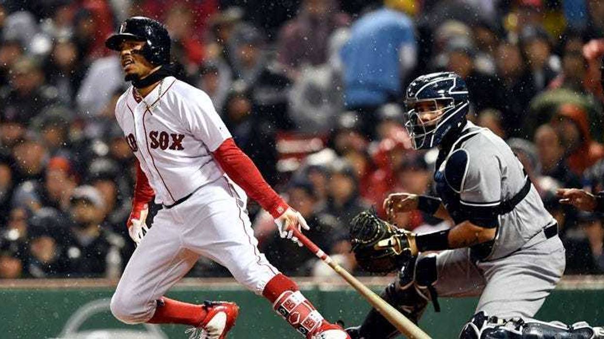The Red Sox's Mookie Betts hits an RBI single in the third inning against the New York Yankees on April 12, 2018, at Fenway Park in Boston.