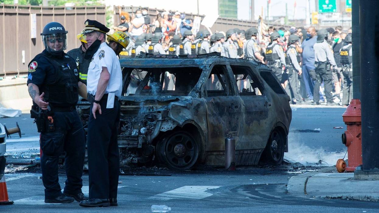 The remains of a police cruiser set on fire near Vine Street and Broad Street during demonstrations Saturday, May 30, 2020 in Philadelphia, Pa.