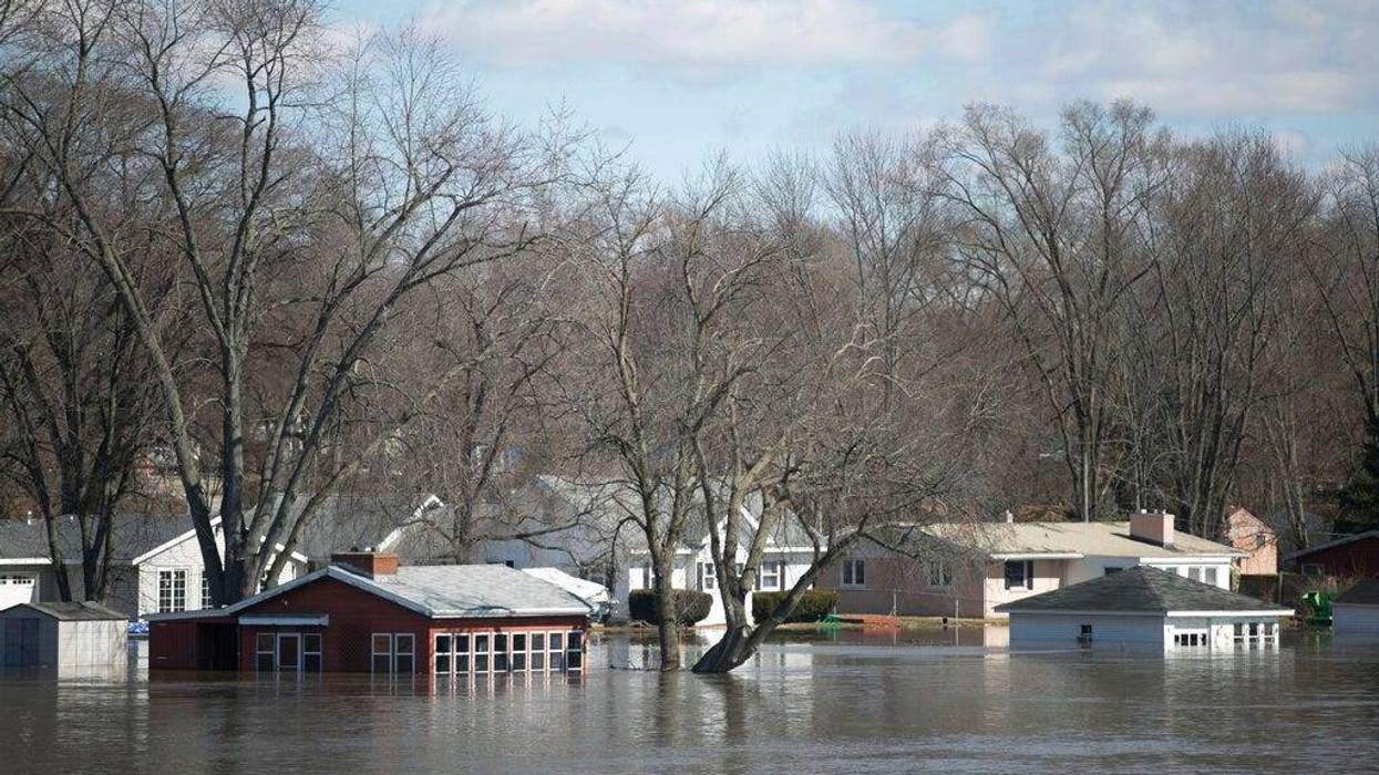 The Rock River crested its banks and floods Shore Drive, seen here on Saturday, March 16, 2019, from the Bauer Parkway bridge in Machesney Park, Ill. Many rivers and creeks in the Midwest are at record levels after days of snow and rain