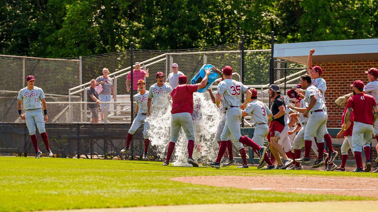 The Saint Joseph’s University baseball team celebrates a win by pouring a cooler on head coach Fritz Hamburg.
