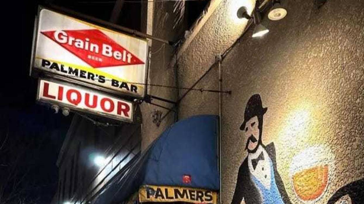 The sign and a visage of a man rarely seen inside Palmer's, one of the Twin Cities' oldest and most famous dive bars.