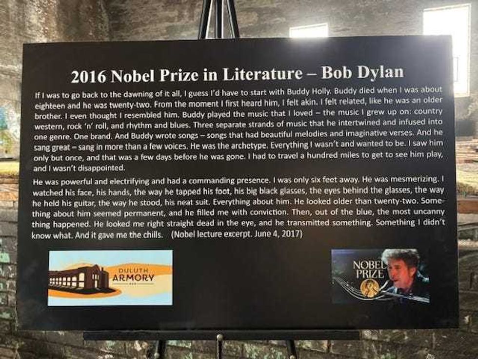 The sign on an easel in the Duluth Armory where Dylan watched concerts, and features a quote on how he was inspired.