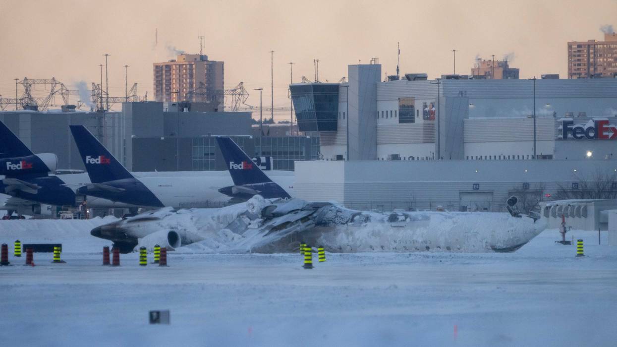 The site of the snow-covered Delta Airline plane crash at Toronto Pearson International Airport on February 18, 2025 in Toronto, Canada. The jet coming in from Minneapolis attempted to land amid strong winds and snow, leading to it crashing and flipping over on the tarmac the day before.