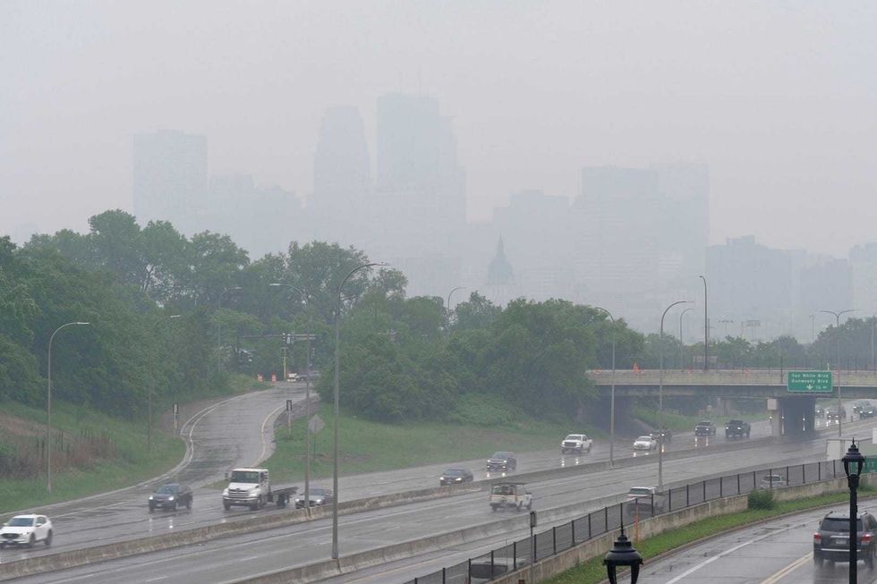 The smell of smoke hung over the Minneapolis-St. Paul area on Tuesday morning despite rain that obscured the full measure of the dirty air.
