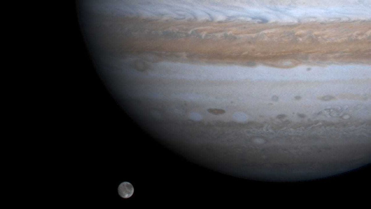 The solar system's largest moon, Ganymede, is captured here alongside the planet Jupiter in this picture taken by NASA's Cassini spacecraft, December 3, 2000.